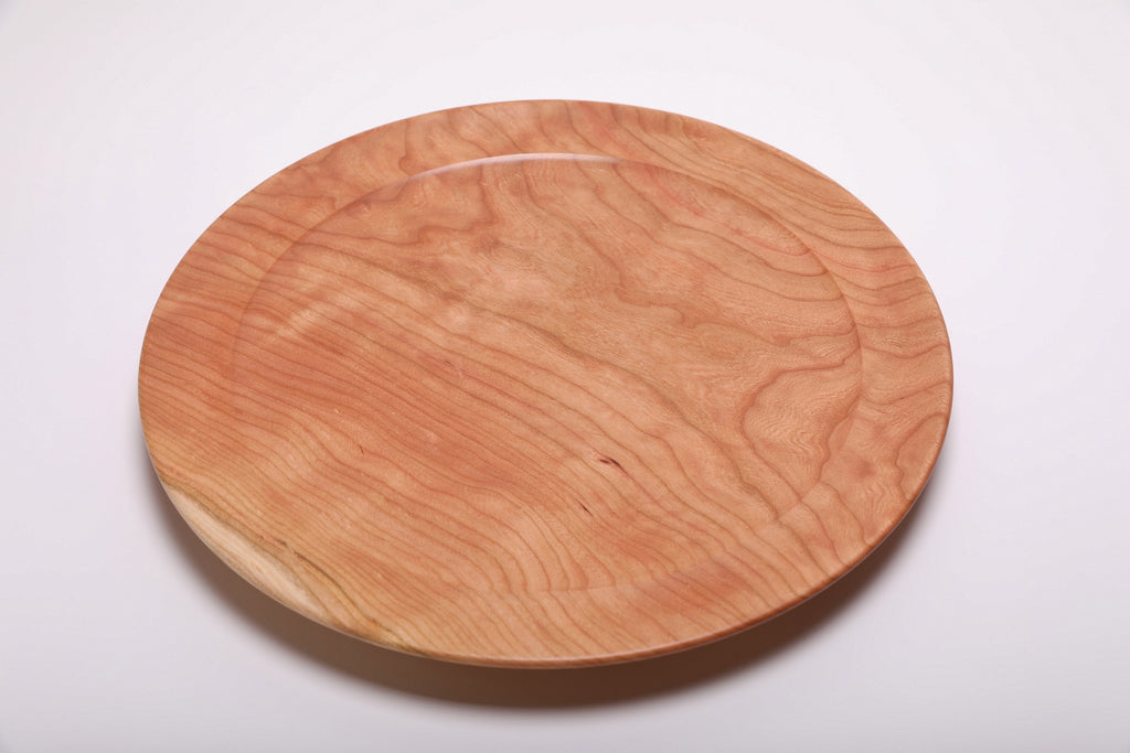 Top view of curly wild black cherry platter highlighting soft pink-orange grain pattern with gentle curly figure and natural oil finish