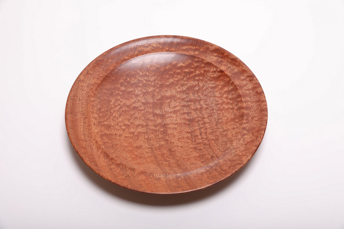Top view of handmade pommele sapele bowl showing dense dappled grain pattern across the entire surface with natural oil finish
