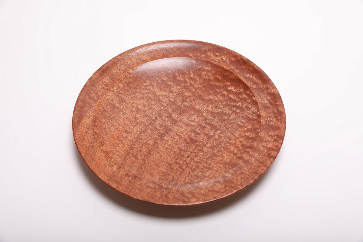 Top view of hand-turned pommele sapele wooden bowl with chatoyant dapple figure revealing warm copper tones and rich mahogany depth