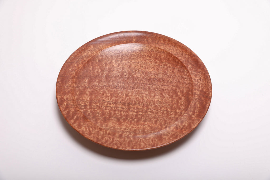 Top view of handmade pommele sapele wooden bowl with full-surface dapple figure and smooth undercut rim, natural oil finish
