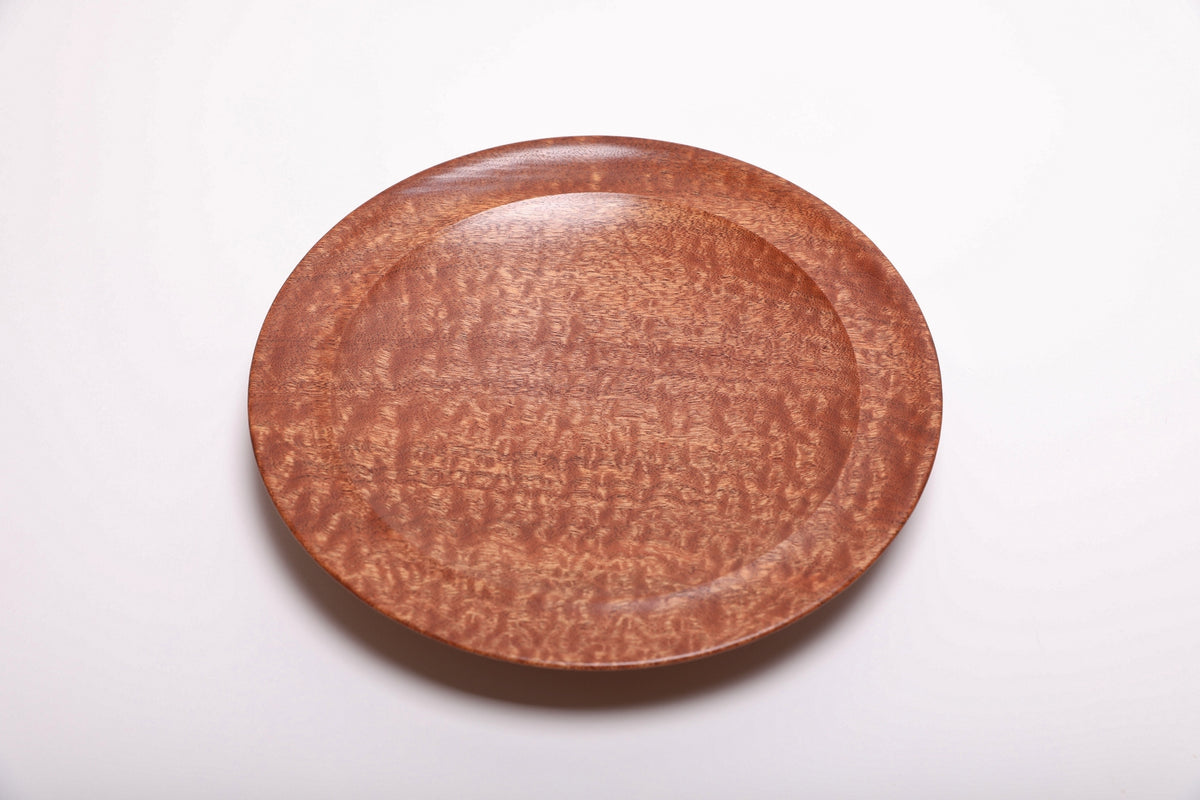 Top view of handmade pommele sapele wooden bowl with full-surface dapple figure and smooth undercut rim, natural oil finish
