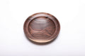 Top view of hand-turned wild black walnut wooden ring dish showing dark chocolate heartwood with bud scar detail and undercut rim, 4 7/8 inches