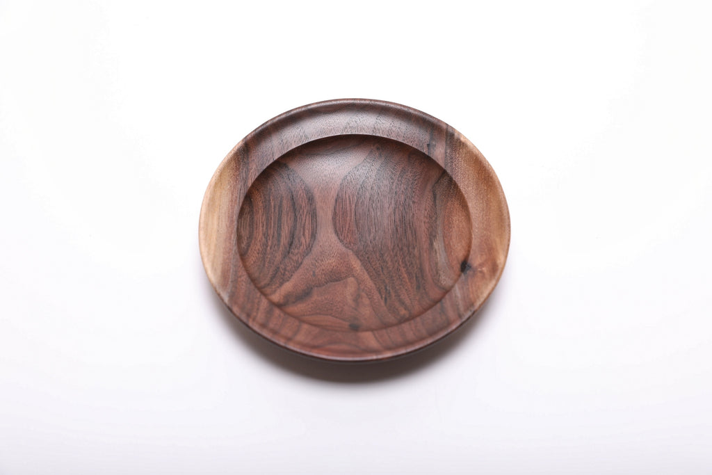 Top view of wild black walnut ring dish highlighting contrasting cream sapwood edge and dark chocolate heartwood with red highlights