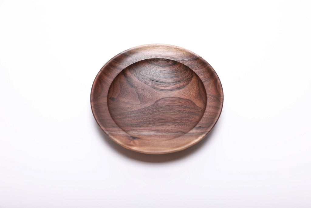 Top view of handmade wild black walnut jewelry dish showing flowing grain pattern, bud scars, and natural oil finish