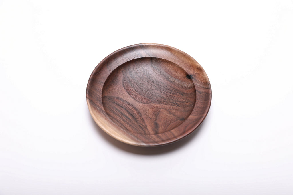Top view of handmade wild black walnut ring dish showing dark heartwood with swirling grain and warm sapwood contrast, natural oil finish
