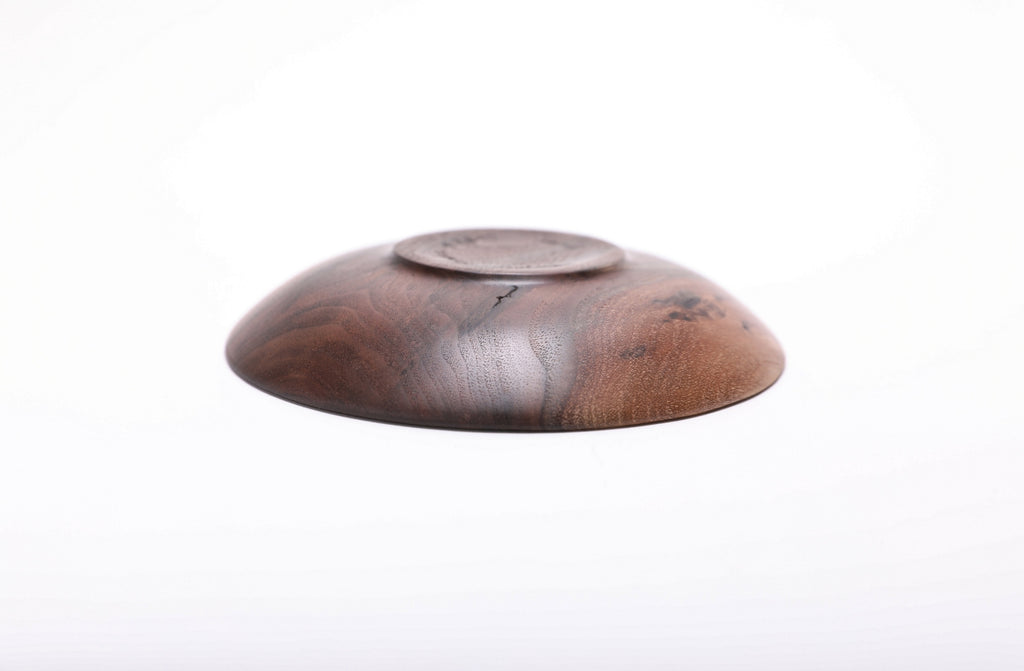 Bottom view of handmade wild black walnut ring dish showing raised foot and natural oil finish