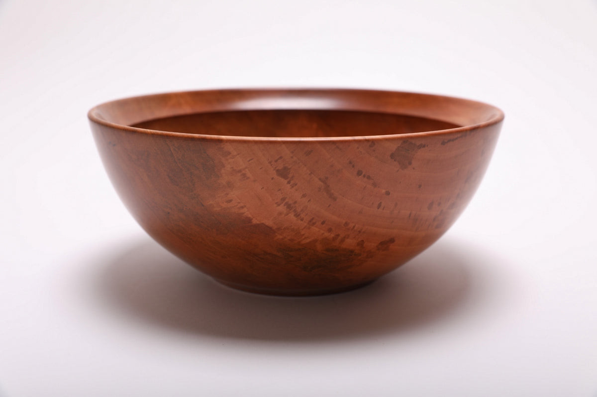 Side view of a hand-turned Bradford pear serving bowl with reddish-brown and salmon coloration