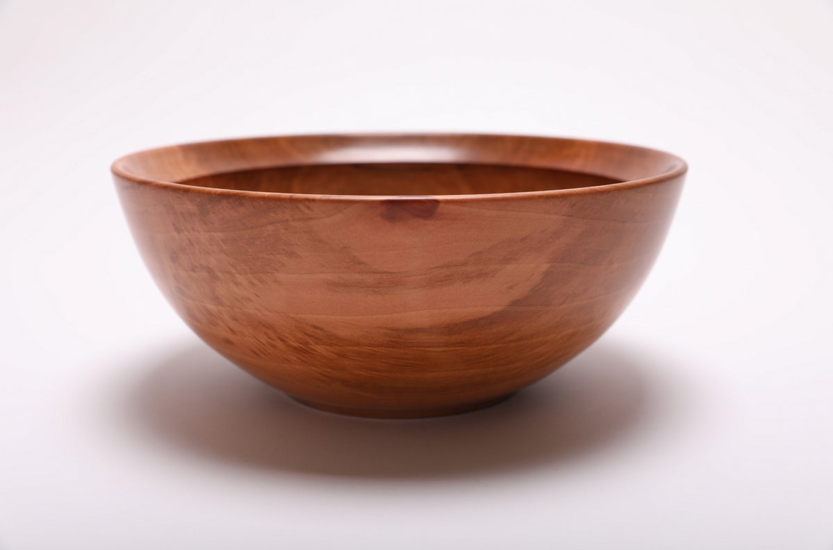 Side view of a Bradford pear bowl showing its rounded rim and raised foot
