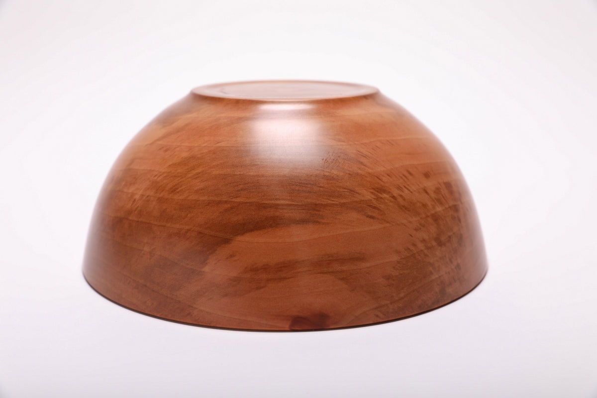 Bottom view of a Bradford pear wooden bowl showing its raised foot and smooth underside