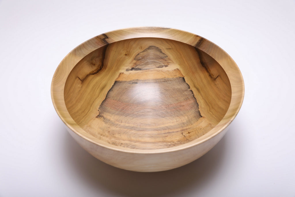 Top view showing the wide interior and colorful grain of a rainbow tulip poplar bowl