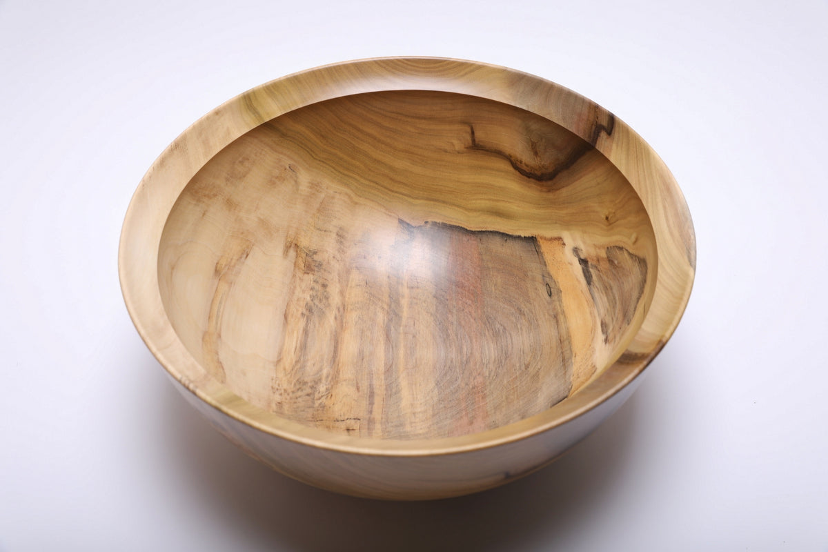Overhead view highlighting the bowl’s natural rainbow-colored tulip poplar grain