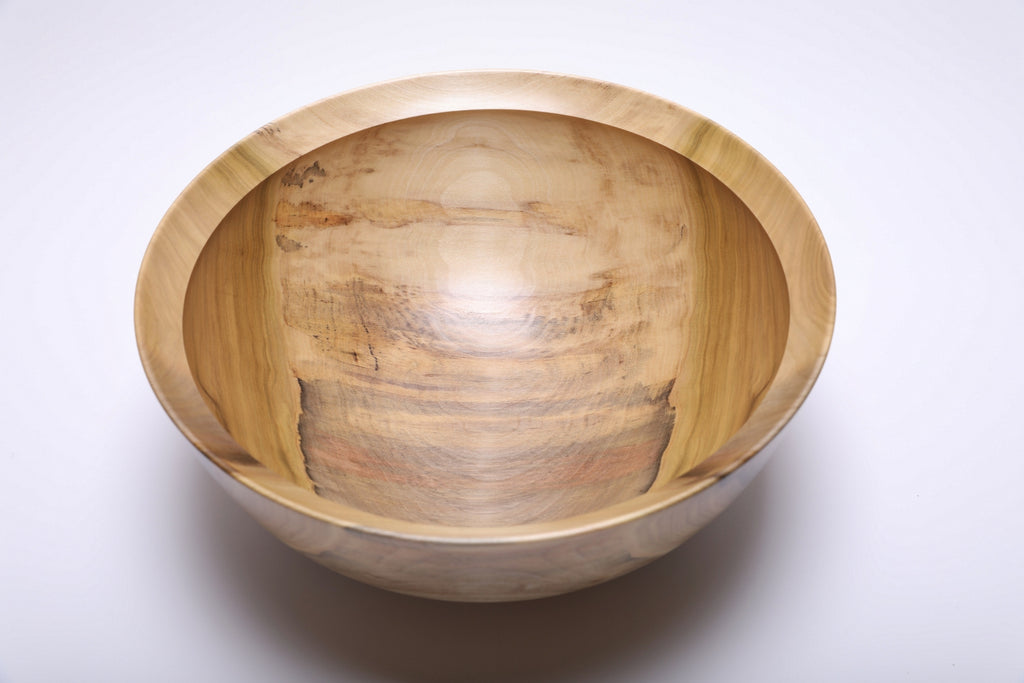 Top view showing the bowl’s broad, curved interior and varied wood colors