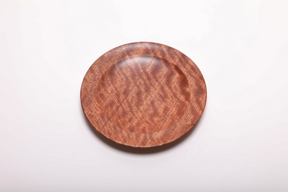 Top view of a pommele sapele ring dish with rich mahogany color and chatoyant figure