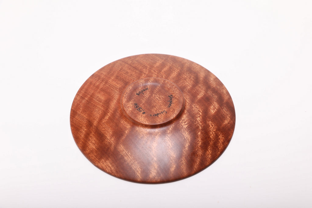 Bottom view of the pommele sapele dish showing its raised foot and wood grain
