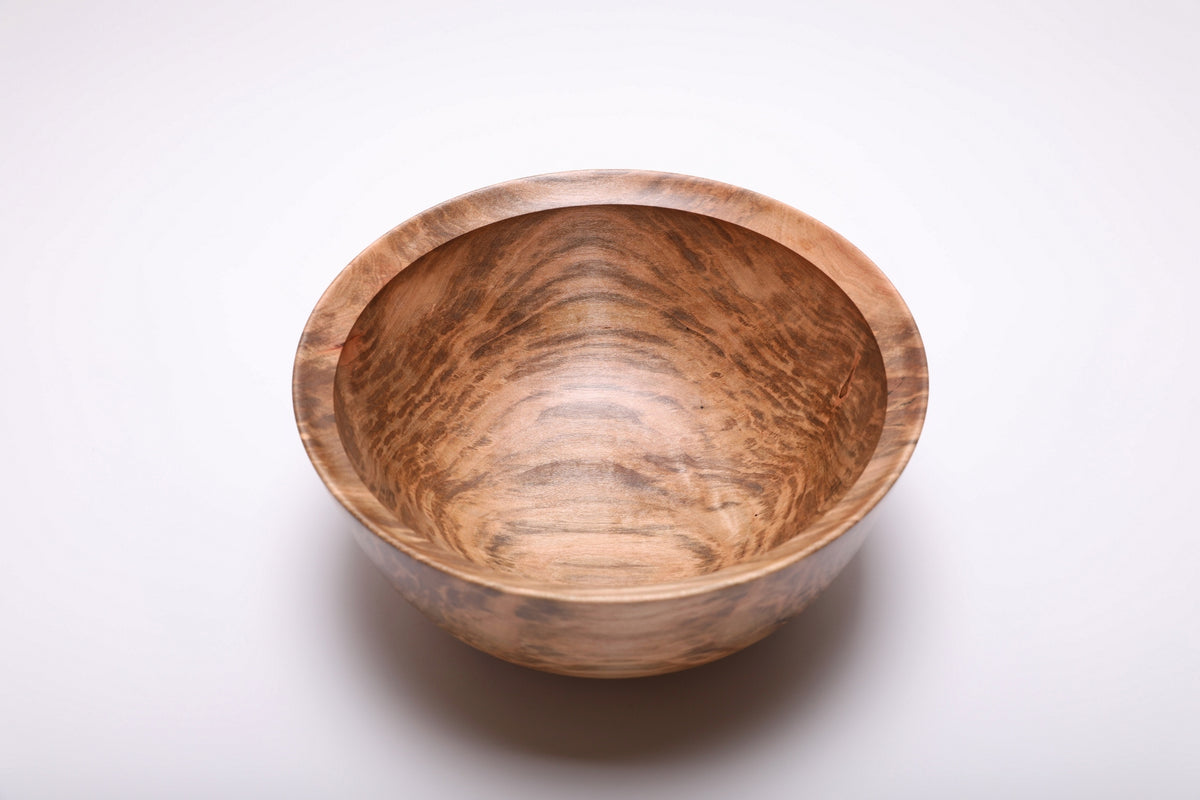 Top view of a spalted ambrosia maple bowl with a pale central band and mottled brown grain