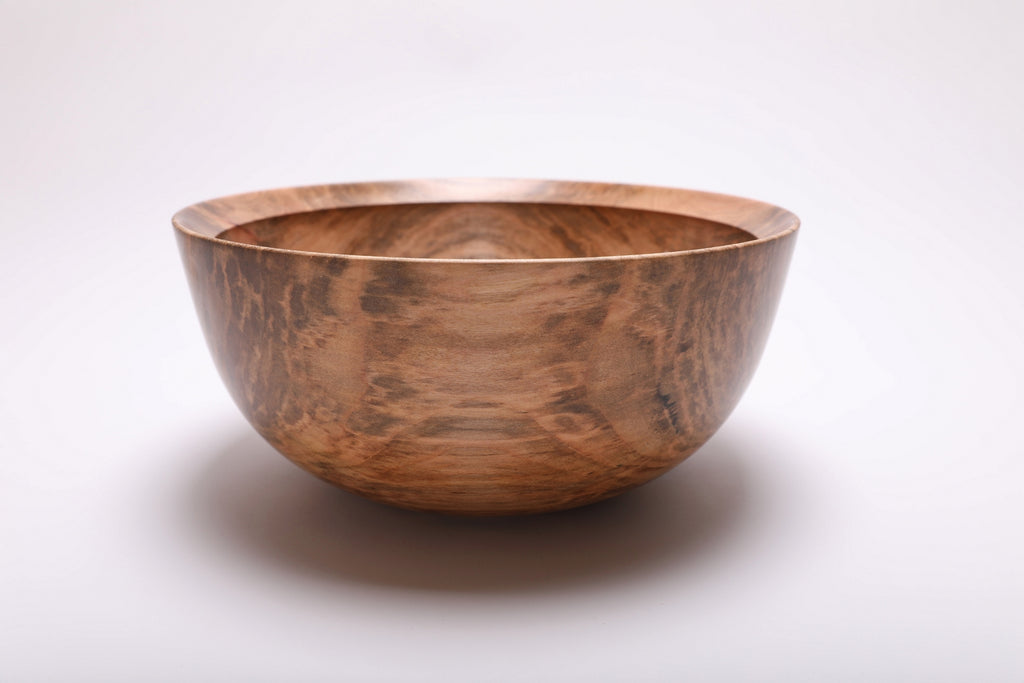 Side view of the spalted maple bowl showing a golden central panel bordered by darker streaks