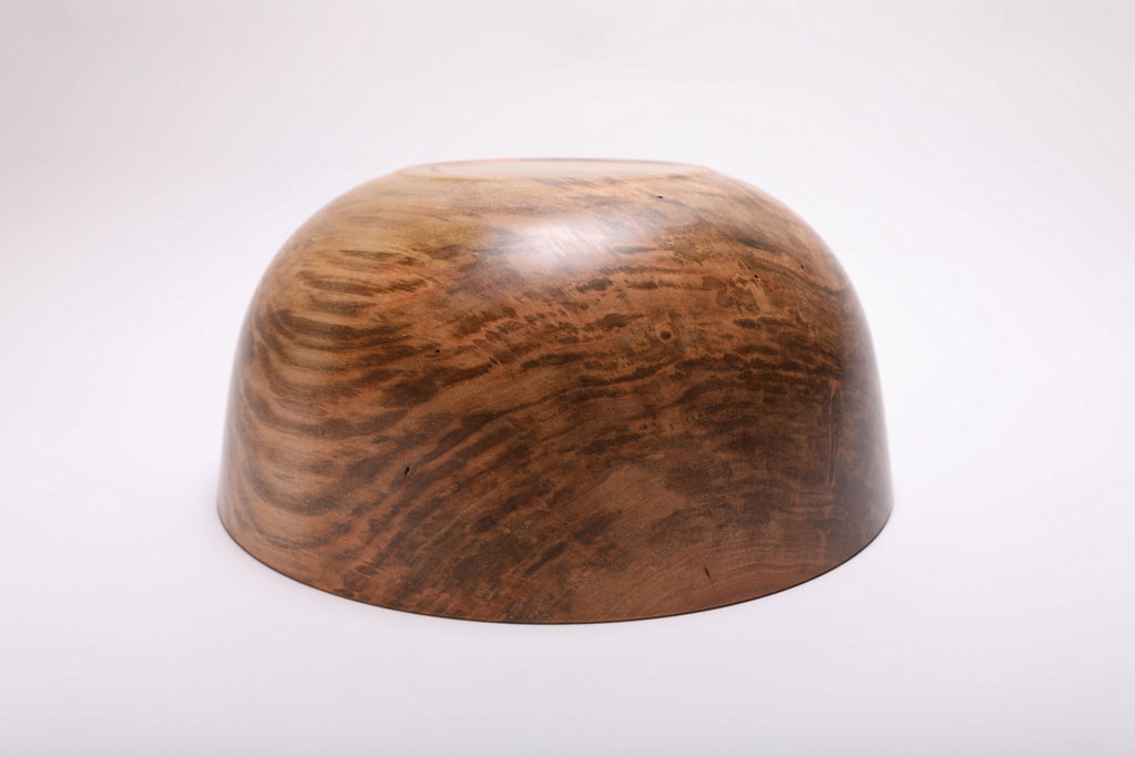 Spalted ambrosia maple bowl turned upside down, showing mottled grain across its curved underside