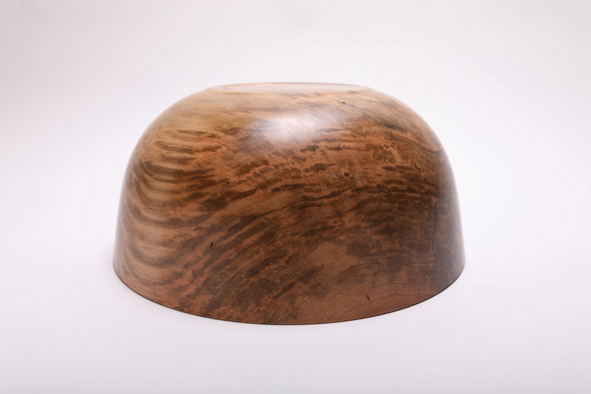 Spalted ambrosia maple bowl turned upside down, showing mottled grain across its curved underside