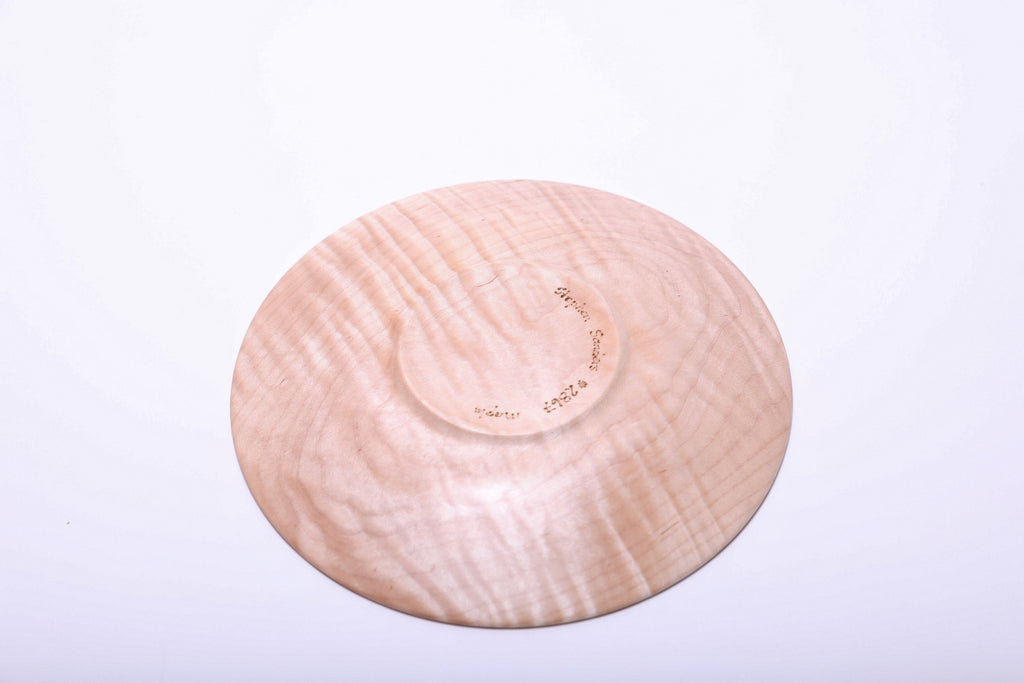 Bottom view of tiger maple wooden dish showing figured grain, a circular foot and handwritten maker markings.