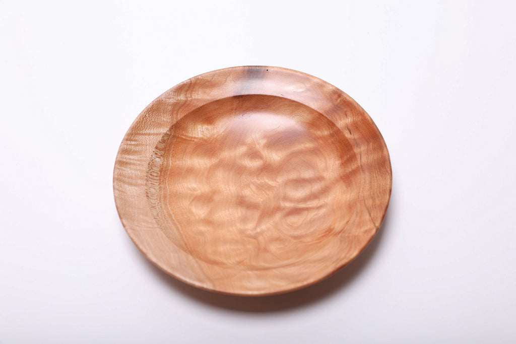 Maple ring dish viewed from above, showing soft waves of quilted grain across its shallow center.