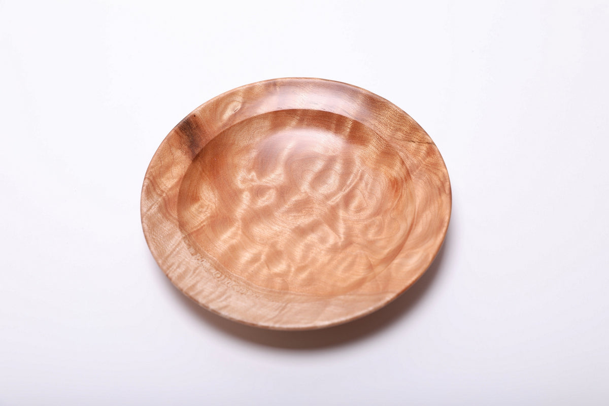 Quilted maple ring dish viewed from above, highlighting pale, looping grain patterns within the rounded rim.
