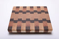 Maple, walnut and cherry end grain cutting board with a wide maple center and interlocking walnut and cherry blocks.