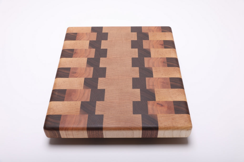 Top view of the rectangular cutting board showing its symmetrical geometric pattern and smooth rounded corners.