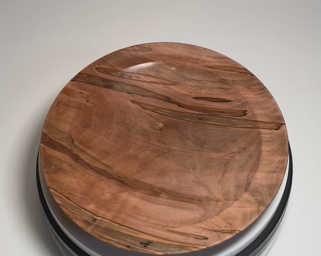 Ambrosia maple shallow wood dish rotating 360 degrees on display stand, showcasing natural beetle holes, ambrosia fungus coloring, and hand-turned form