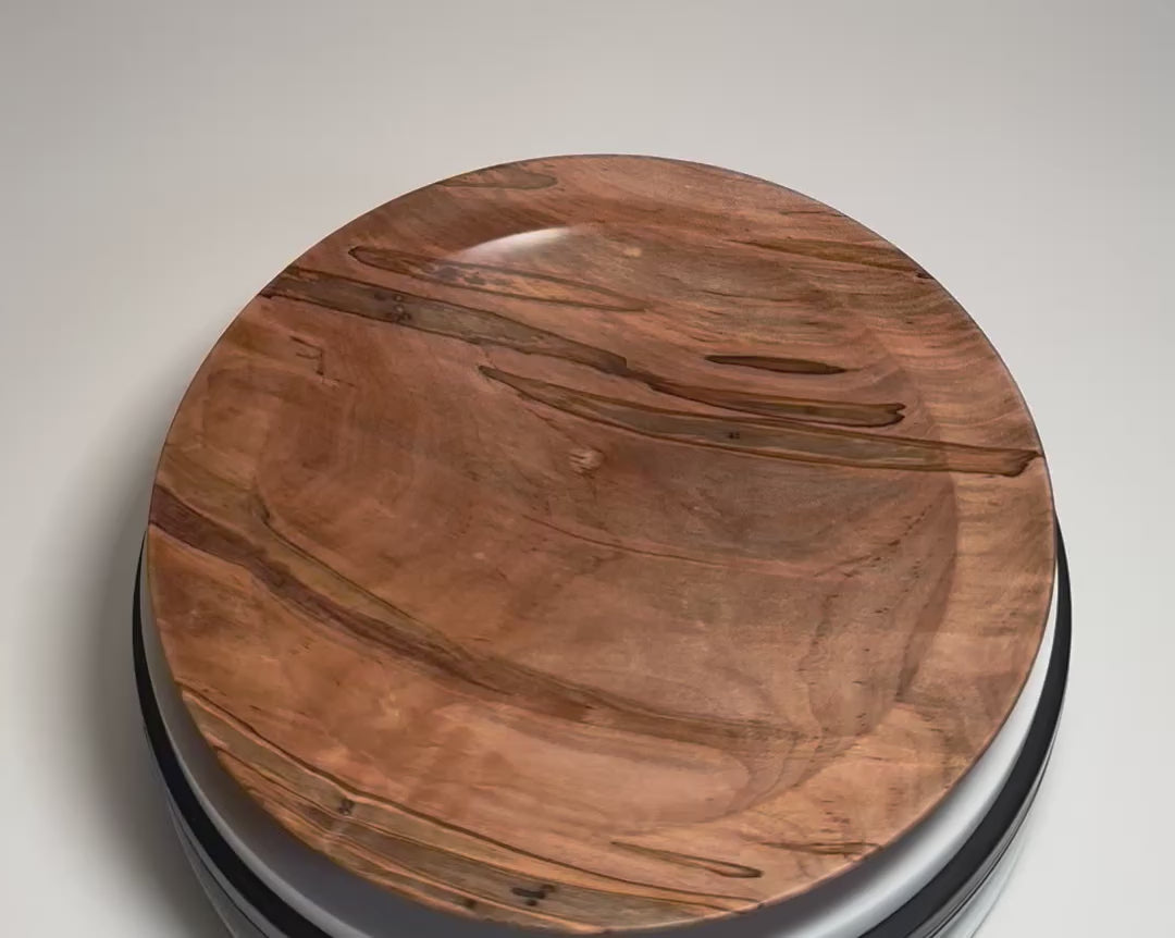 Ambrosia maple shallow wood dish rotating 360 degrees on display stand, showcasing natural beetle holes, ambrosia fungus coloring, and hand-turned form