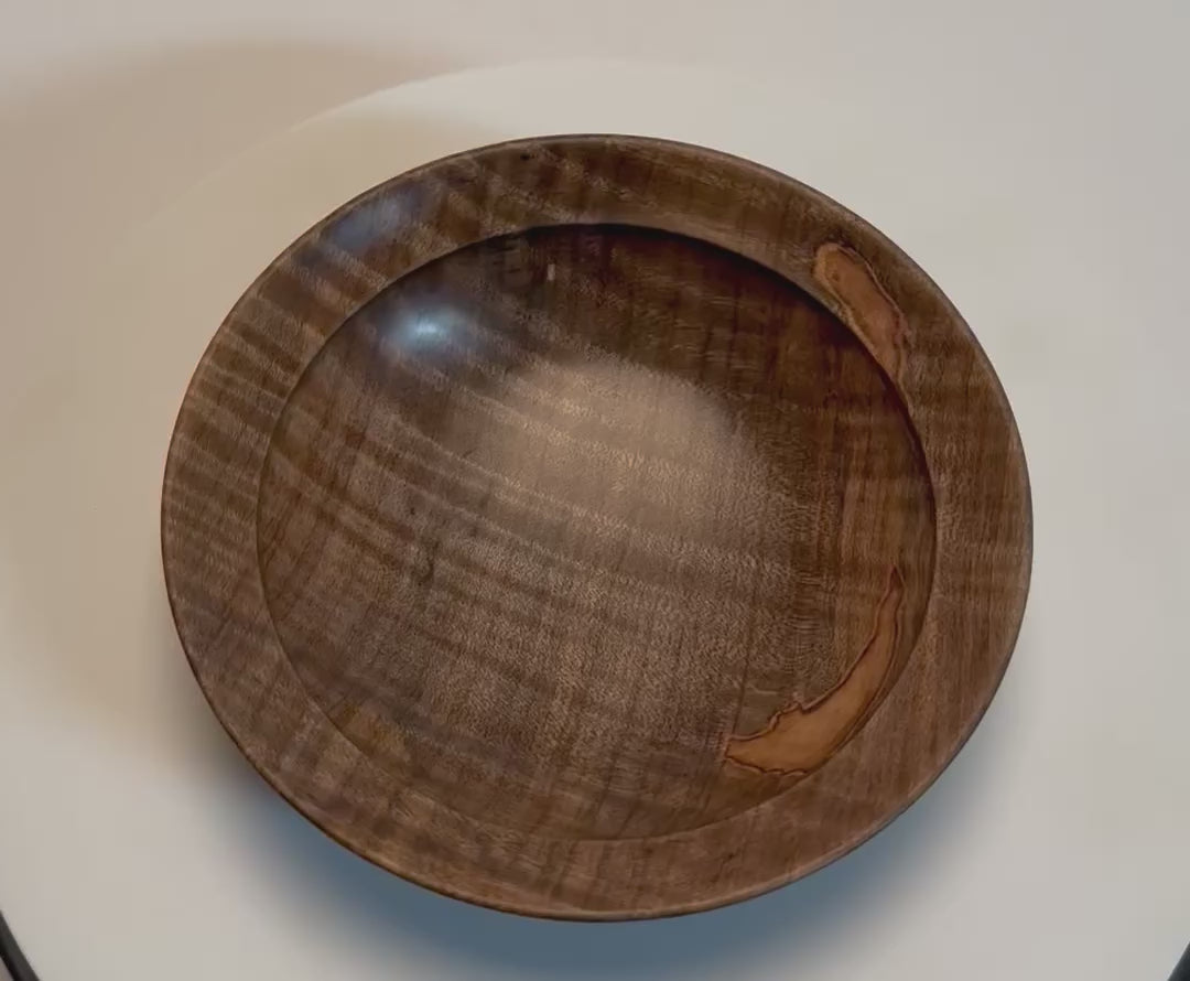 Spalted tiger ambrosia maple wooden bowl rotating 360° on display stand, showcasing chatoyant tiger figure, spalting, ambrosia patch, and handcrafted oil finish — Sanders Woodworking

