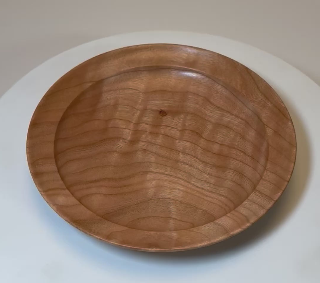 360-degree view of wild black cherry ring dish showing chatoyant quilted figure shifting in light and bud scar detail