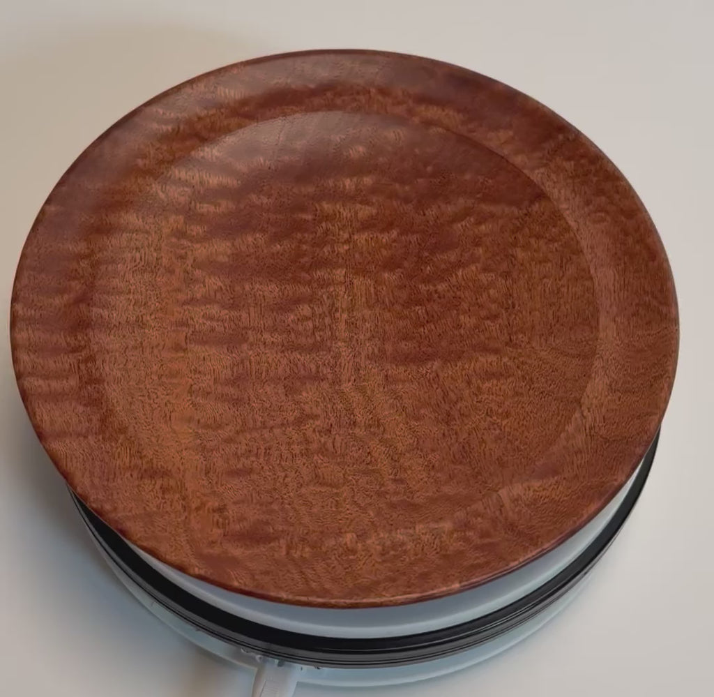Pommele sapele shallow bowl rotating to show chatoyant figure and mahogany-copper grain, handmade by Sanders Woodworking
