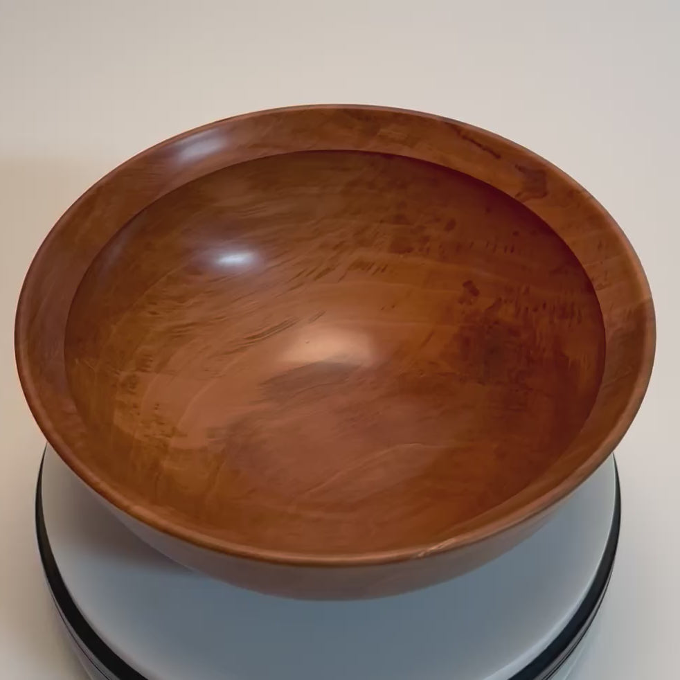 Top view video of a Bradford pear wooden bowl rotating on a display, showing its natural grain and ambrosia streaks