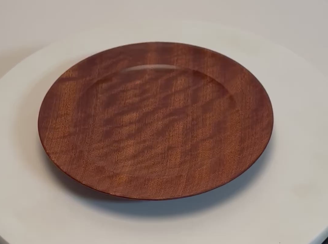 Pommele ribbon sapele wooden ring dish rotating 360° on display stand, showcasing chatoyant figure, ribbon grain, and handcrafted oil finish — Sanders Woodworking