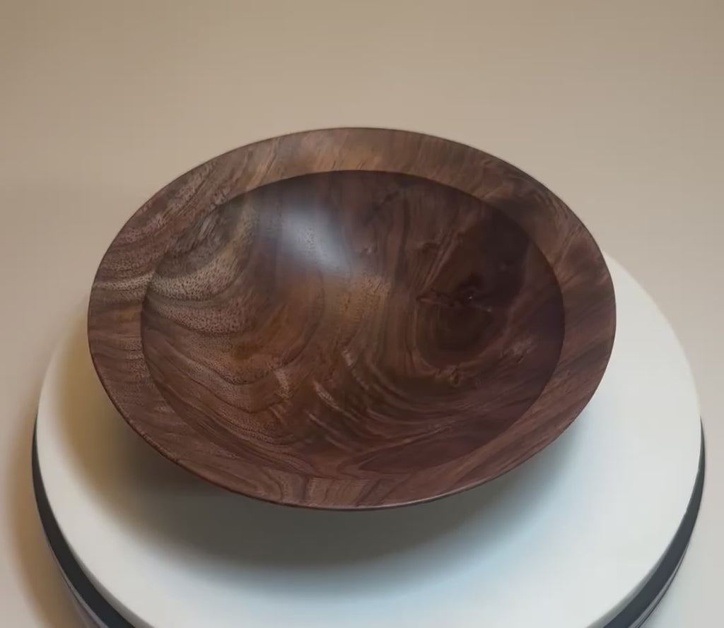 Wild black walnut crotch burl wooden bowl rotating 360° on display stand, showcasing crotch burl figure, repaired knot, curly growth rings, and food-safe oil finish — Sanders Woodworking
