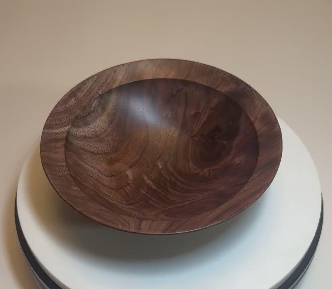 Wild black walnut crotch burl wooden bowl rotating 360° on display stand, showcasing crotch burl figure, repaired knot, curly growth rings, and food-safe oil finish — Sanders Woodworking