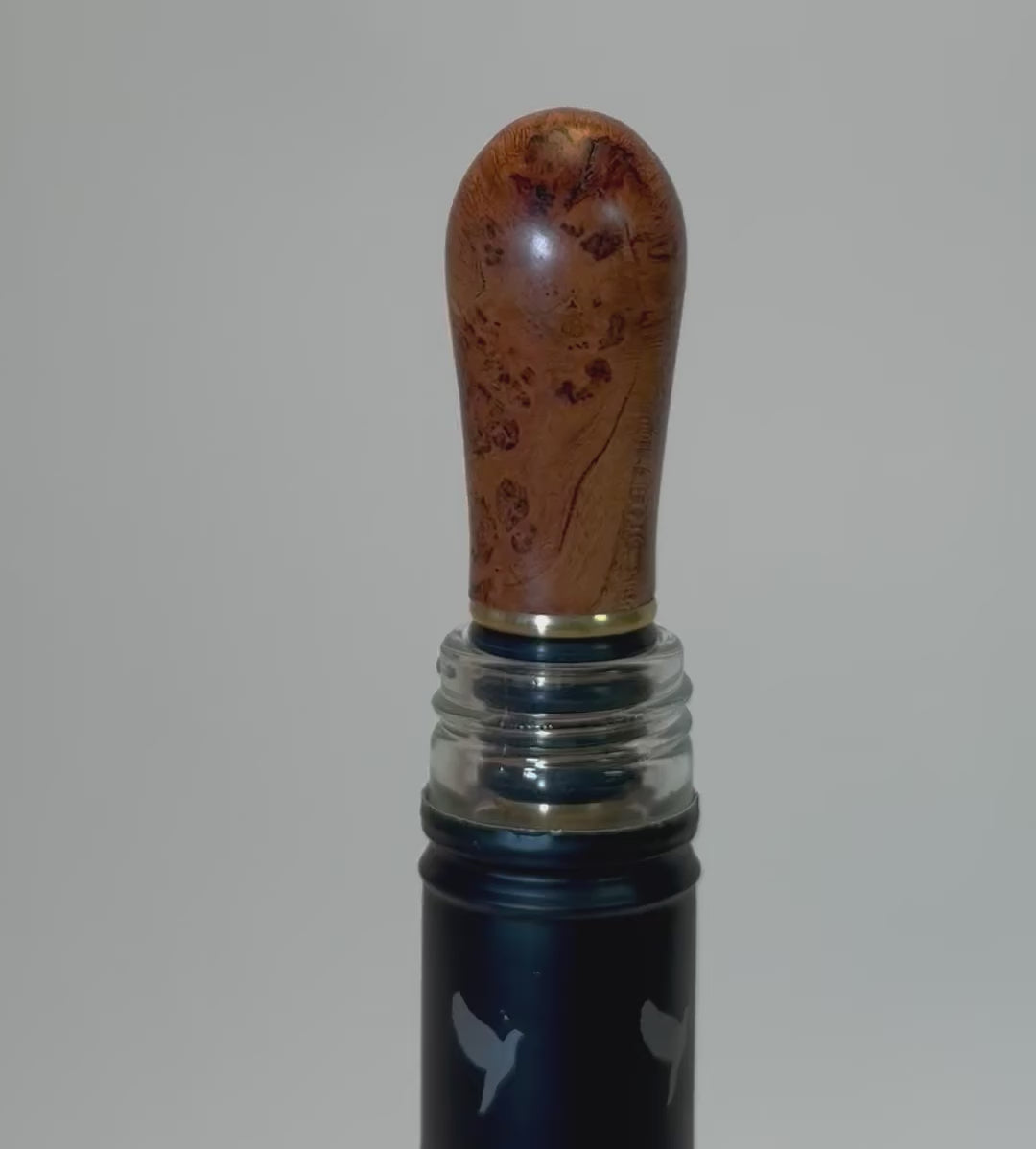 360-degree view of wild black cherry burl wine stopper showing birdseye figure, bark inclusions, and copper wood tones