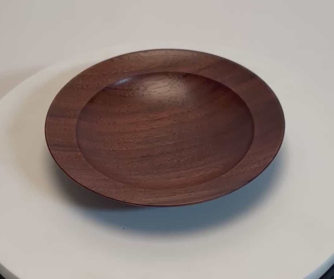 Quartersawn wild black walnut wooden ring dish rotating 360° on display stand, showcasing straight growth rings, chocolate grain lines, and handcrafted oil finish — Sanders Woodworking
