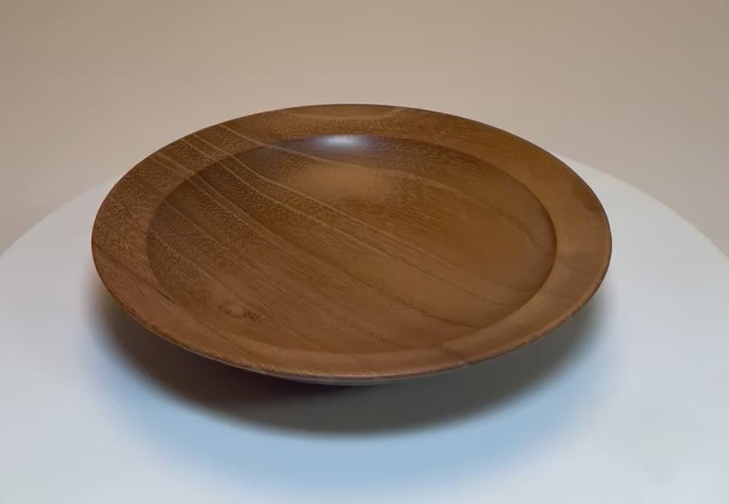 Small black locust wooden bowl rotating 360 degrees on display stand showing iridescent wood grain and natural figure, Sanders Woodworking