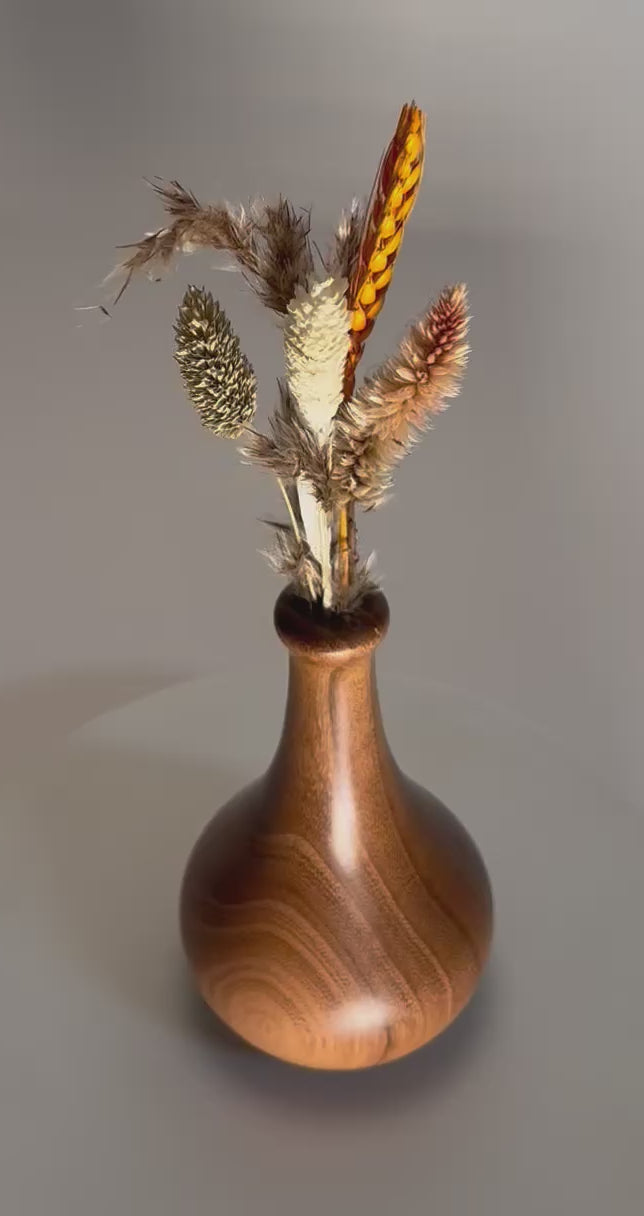 Black locust wood weed pot rotating 360 degrees on display stand, showcasing wide growth rings, slender neck, and hand-turned form