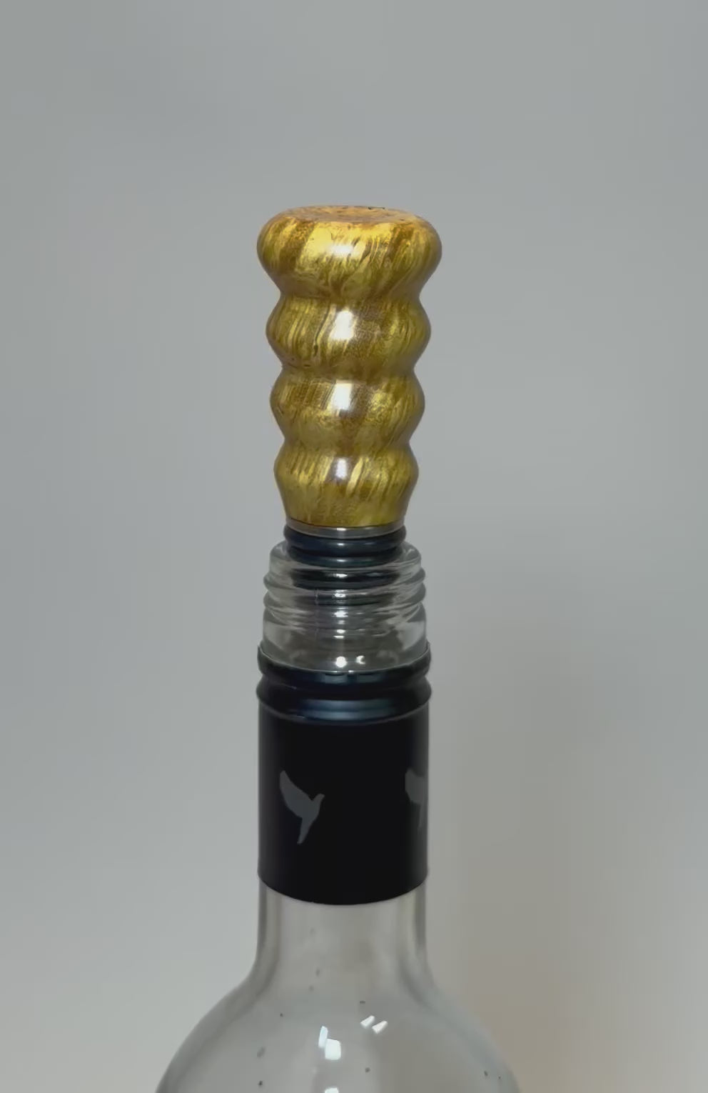 Video showcasing mulberry burl wine stopper with canary yellow coloration and iridescent grain patterns