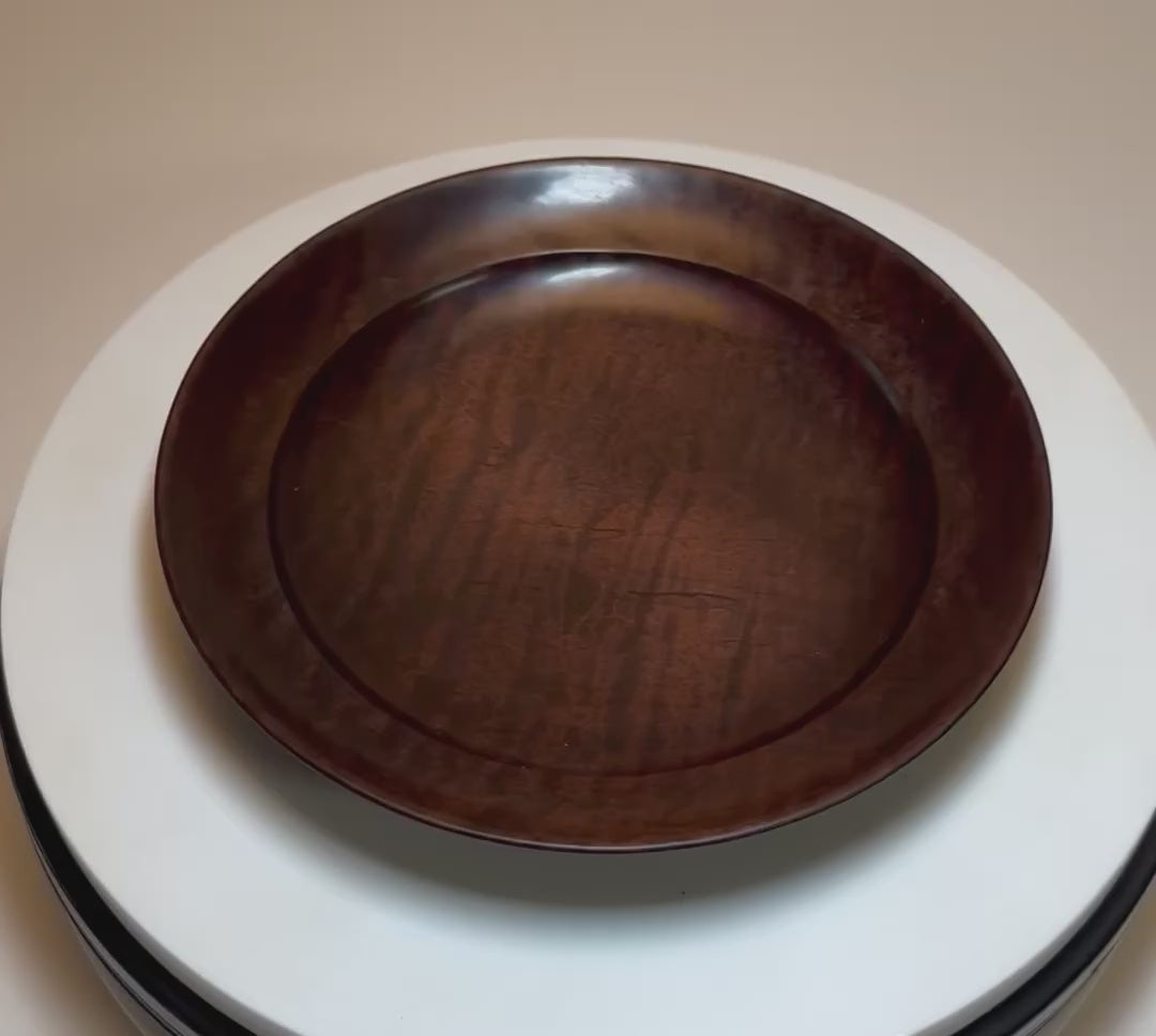 Video of roasted tiger maple wooden bowl rotating to show chatoyant figure
