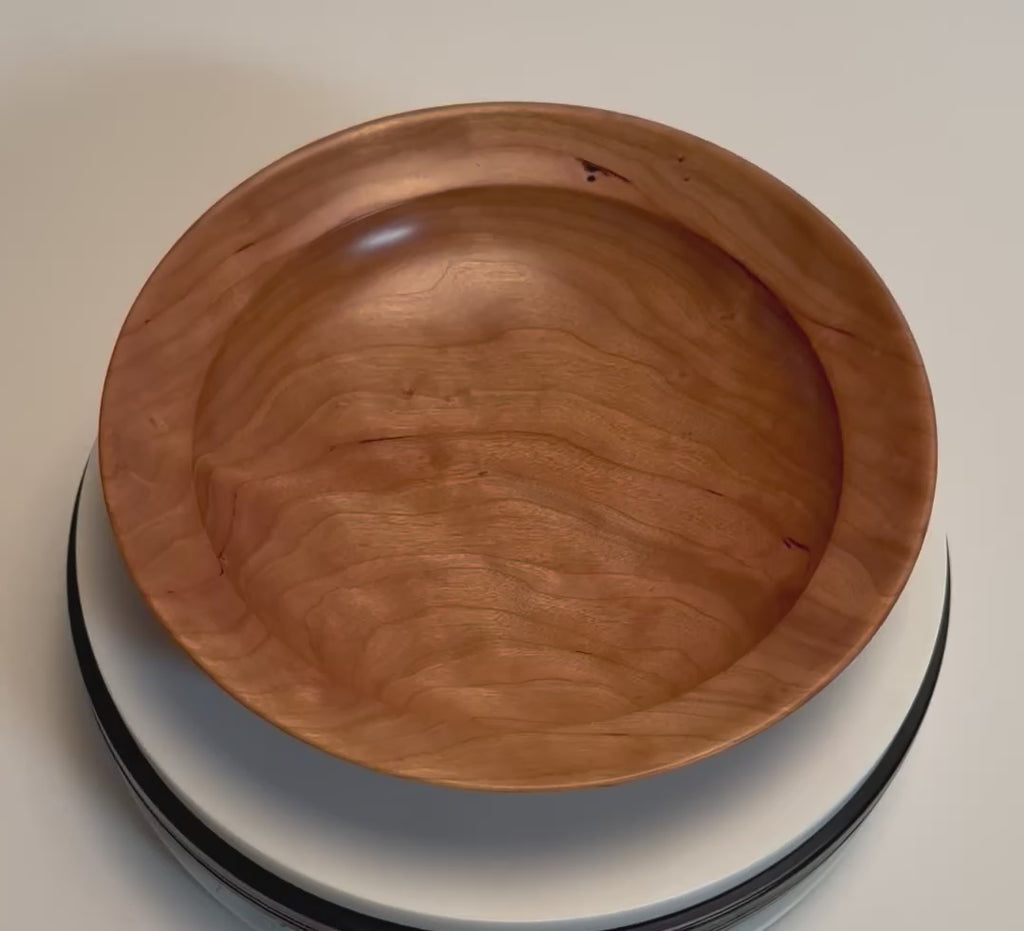 Wild black cherry wooden bowl rotating to show chatoyant figure and amber grain, handmade by Sanders Woodworking