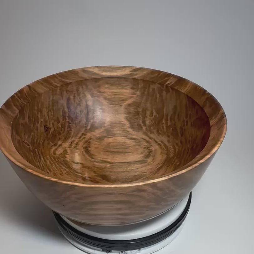 Spalted ambrosia maple bowl rotating on a display, revealing its patterned grain and rounded shape	