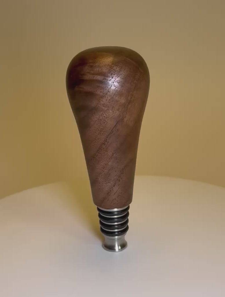 Video demonstration of walnut burl wine bottle stopper showing craftsmanship and stainless steel mechanism