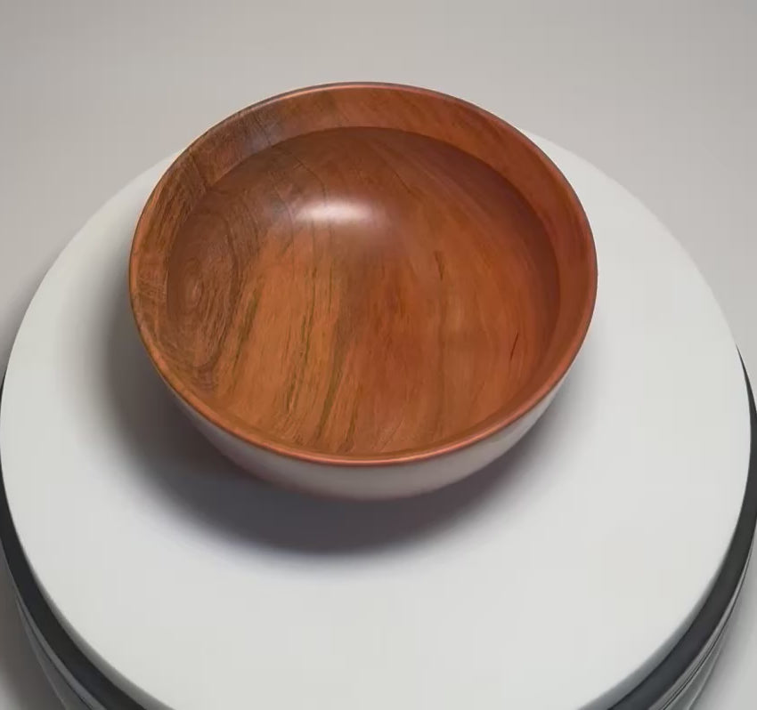 Hand-turned wild black cherry wood bowl rotating 360°, showing natural spalting, curved undercut rim, raised foot, and food-safe oil finish — handmade in NC by Sanders Woodworking	
