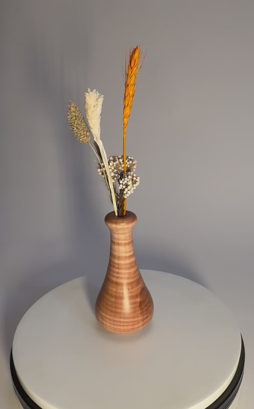 Handcrafted tiger maple weed pot rotating on display stand with dried flowers (not included) – 360° view of chatoyant curly figure and natural oil finish