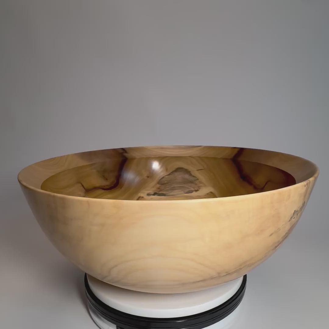 Side view as the bowl rotates, showing its curved profile, rounded rim, and raised foot